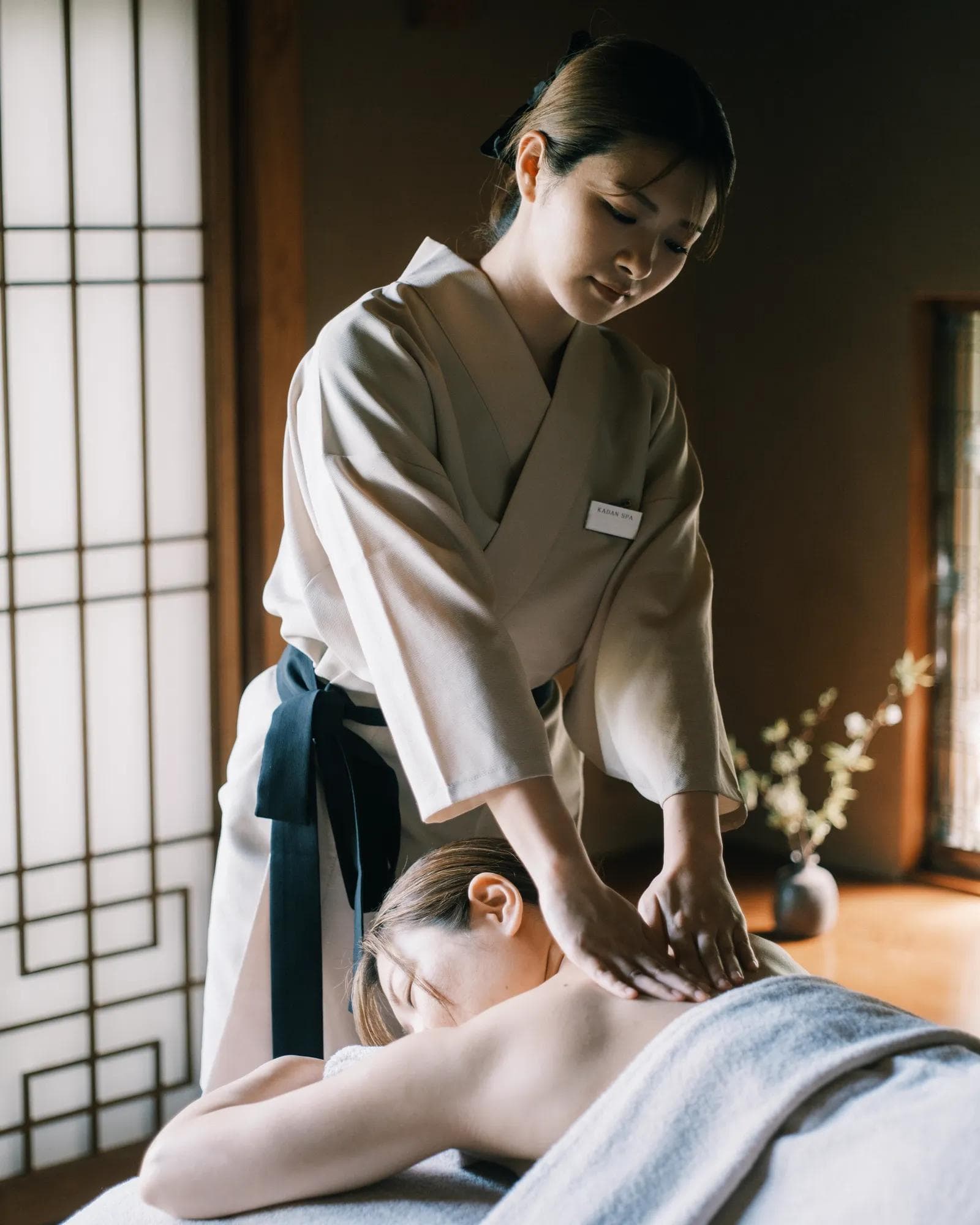 Massage therapist massaging guest